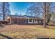 Charming brick home featuring a well-maintained front yard with mature trees and traditional architecture at 2826 Summit Ridge Dr, Marietta, GA 30066