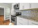 This kitchen features stainless steel appliances, granite countertops and tiled backsplash at 2826 Summit Ridge Dr, Marietta, GA 30066