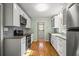 Modern kitchen boasts white cabinets, granite countertops, stainless steel appliances, and stylish backsplash at 2826 Summit Ridge Dr, Marietta, GA 30066