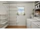 A laundry room with shelves, washer and dryer, and a window providing natural light at 2826 Summit Ridge Dr, Marietta, GA 30066