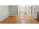 Spacious open-concept living area with a classic brick fireplace and gleaming hardwood floors at 2826 Summit Ridge Dr, Marietta, GA 30066