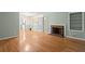 Open-concept living area with a classic brick fireplace and gleaming hardwood floors at 2826 Summit Ridge Dr, Marietta, GA 30066