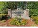 Stonepark private residences community sign with stone pillars and manicured flower bed at 7007 Wingate Way, Atlanta, GA 30350