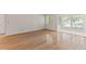 A bright living room with hardwood floors and a tiled sun room in a modern home at 7007 Wingate Way, Atlanta, GA 30350