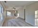 Large bedroom with a ceiling fan, large windows, and neutral carpet and paint at 285 Belmont Trl, Covington, GA 30016