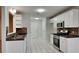 Updated kitchen featuring white cabinets, stainless steel appliances, and tile flooring at 285 Belmont Trl, Covington, GA 30016