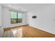 Bright living room featuring hardwood floors, a large window, and a wall-mounted TV bracket at 821 Ralph Mcgill Ne Blvd # 3104, Atlanta, GA 30306