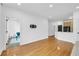Open-concept living room with hardwood floors, wall-mounted TV, and view of the kitchen and bedroom at 821 Ralph Mcgill Ne Blvd # 3104, Atlanta, GA 30306