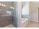 Modern bathroom with a tiled walk-in shower and soaking tub, offering a spa-like experience at 113 Maplewood Ln, Conyers, GA 30094