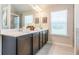 Double vanity in a well-lit bathroom, featuring dark wood cabinets and quartz countertops at 113 Maplewood Ln, Conyers, GA 30094