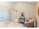Bright bedroom features neutral walls, carpet floors, an accent chair and closet with double doors at 113 Maplewood Ln, Conyers, GA 30094