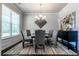 Chic dining room with a round table, gray chairs, modern lighting, and stylish decor at 113 Maplewood Ln, Conyers, GA 30094