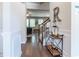 Elegant foyer featuring hardwood floors, staircase, and stylish decor at 113 Maplewood Ln, Conyers, GA 30094