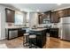 Charming kitchen with a central island, stainless steel appliances, and dark wood cabinets at 113 Maplewood Ln, Conyers, GA 30094