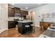 Open concept kitchen with dark cabinets, stainless appliances, and a central island with bar stools at 113 Maplewood Ln, Conyers, GA 30094