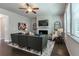 Comfortable living room with a fireplace, TV, ceiling fan and large windows for natural light at 113 Maplewood Ln, Conyers, GA 30094