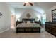 Relaxing main bedroom featuring a vaulted ceiling, ceiling fan, and decorative wall art at 113 Maplewood Ln, Conyers, GA 30094