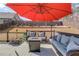Deck featuring a wicker seating and a patio umbrella at 1217 Trophy Club Ave, Dacula, GA 30019