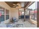 Covered back patio with seating area, ceiling fan, and outdoor access at 1217 Trophy Club Ave, Dacula, GA 30019