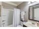 Cozy bathroom featuring a shower-tub combo, vanity sink, and framed mirror at 1217 Trophy Club Ave, Dacula, GA 30019