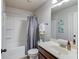 Neutral bathroom features a shower and tub combination, a white vanity and a large mirror at 1217 Trophy Club Ave, Dacula, GA 30019