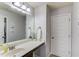 Neutral bathroom has a large mirror, white vanity and a door to the hallway at 1217 Trophy Club Ave, Dacula, GA 30019