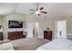 Spacious bedroom with vaulted ceilings, ceiling fan, a seating area, and ensuite bathroom at 1217 Trophy Club Ave, Dacula, GA 30019