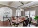 Elegant dining room with decorative ceiling, stylish lighting, and seating for a large gathering at 1217 Trophy Club Ave, Dacula, GA 30019