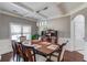Formal dining room featuring coffered ceilings, elegant lighting, and ample seating for eight at 1217 Trophy Club Ave, Dacula, GA 30019