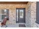Inviting front entry features a modern door, brick facade, and a cozy welcome mat at 1217 Trophy Club Ave, Dacula, GA 30019