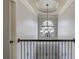 Elegant hallway featuring a decorative chandelier and a large arched window at 1217 Trophy Club Ave, Dacula, GA 30019