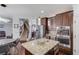 Island kitchen with a large breakfast bar, stainless appliances, and modern pendant lighting at 1217 Trophy Club Ave, Dacula, GA 30019