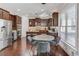Eat-in kitchen with stainless appliances, granite countertops, dark wood cabinetry, and pendant lighting at 1217 Trophy Club Ave, Dacula, GA 30019