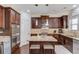 Open kitchen featuring granite counters, stainless appliances, wood cabinets, and a center island at 1217 Trophy Club Ave, Dacula, GA 30019