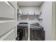 Well-organized laundry room boasts modern washer and dryer, plus shelving for storage at 1217 Trophy Club Ave, Dacula, GA 30019