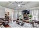 Cozy living room with stone fireplace, coffered ceiling, and seamless flow to the kitchen at 1217 Trophy Club Ave, Dacula, GA 30019