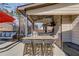 Covered outdoor kitchen featuring granite counters, bar seating, and mounted TV at 1217 Trophy Club Ave, Dacula, GA 30019