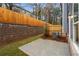 A fenced in backyard with a small patio and grass at 1016 Rose Dr, Marietta, GA 30060