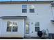 Exterior view of the home's back featuring light-colored vinyl siding and many windows at 4620 Grand Central Pkwy, Decatur, GA 30035