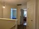 Upstairs hallway with carpet and two doors, with views of bedrooms and a light fixture at 4620 Grand Central Pkwy, Decatur, GA 30035