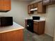 Kitchen with wood cabinets, laminate countertops, black appliances including range and microwave at 4620 Grand Central Pkwy, Decatur, GA 30035