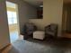 Cozy living room featuring two armchairs and an ottoman on top of neutral carpeting at 4620 Grand Central Pkwy, Decatur, GA 30035