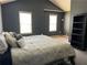 Main bedroom with vaulted ceiling, two windows, dark walls and carpet at 4620 Grand Central Pkwy, Decatur, GA 30035