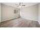 Empty bedroom highlighting hardwood floors, bright walls, a ceiling fan, and a large window at 6715 Knollwood Cir, Douglasville, GA 30135