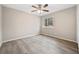 Empty bedroom highlighting hardwood floors, bright walls, a ceiling fan, and a large window at 6715 Knollwood Cir, Douglasville, GA 30135