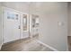 Bright foyer featuring modern flooring, a stylish front door, and a glimpse into the updated kitchen at 6715 Knollwood Cir, Douglasville, GA 30135