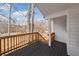 Inviting covered porch showcasing stained wood railings and a peaceful neighborhood view surrounded by mature trees at 6715 Knollwood Cir, Douglasville, GA 30135