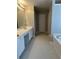 Bathroom features an extended vanity with a makeup station, neutral walls and tile flooring at 3305 Wickum Sw Rd, Atlanta, GA 30349