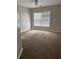Bedroom featuring plush carpet and natural light from a large window at 3305 Wickum Sw Rd, Atlanta, GA 30349