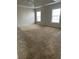 Spacious bedroom featuring plush carpeting, neutral walls, and a tray ceiling with natural light from large windows at 3305 Wickum Sw Rd, Atlanta, GA 30349